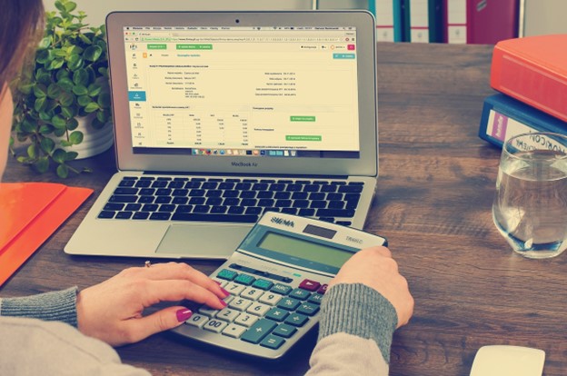 A virtual bookkeeping assistant crunching numbers at a laptop