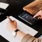 A bookkeeper crunching numbers at a desk.