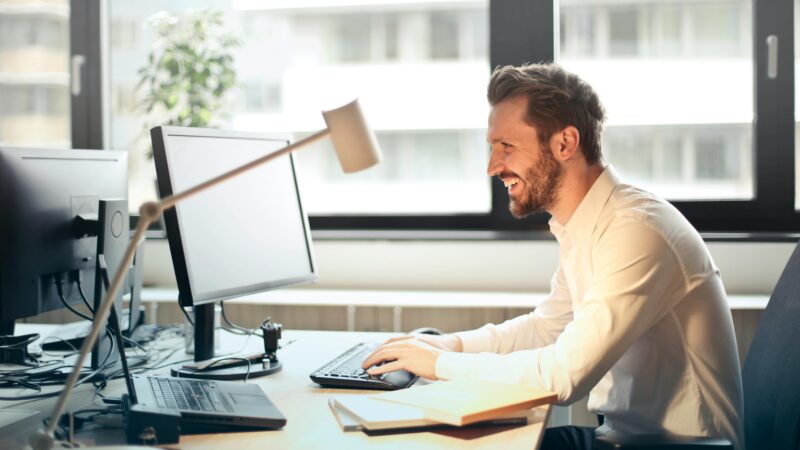 A man sitting at a desk working on a computer